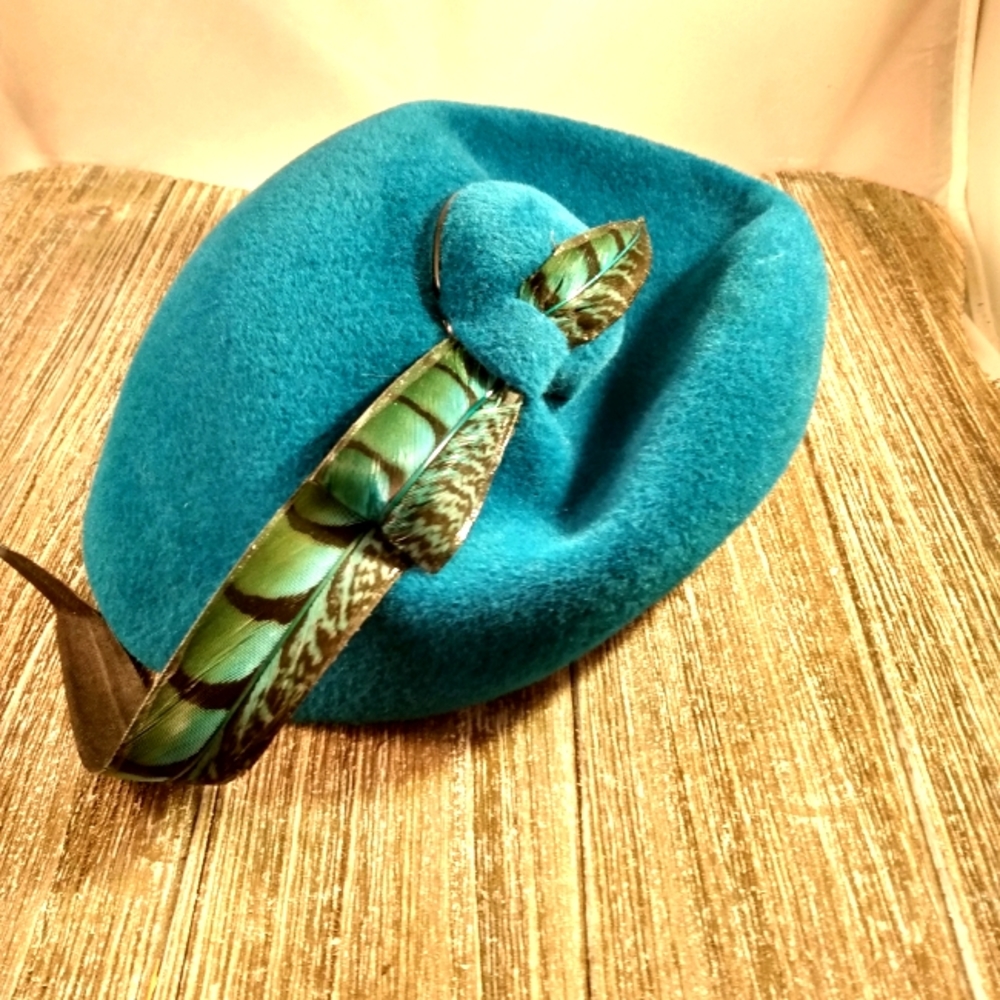 This is a stunning Adolfo II teal wool felt hat with a beautiful feather accent.